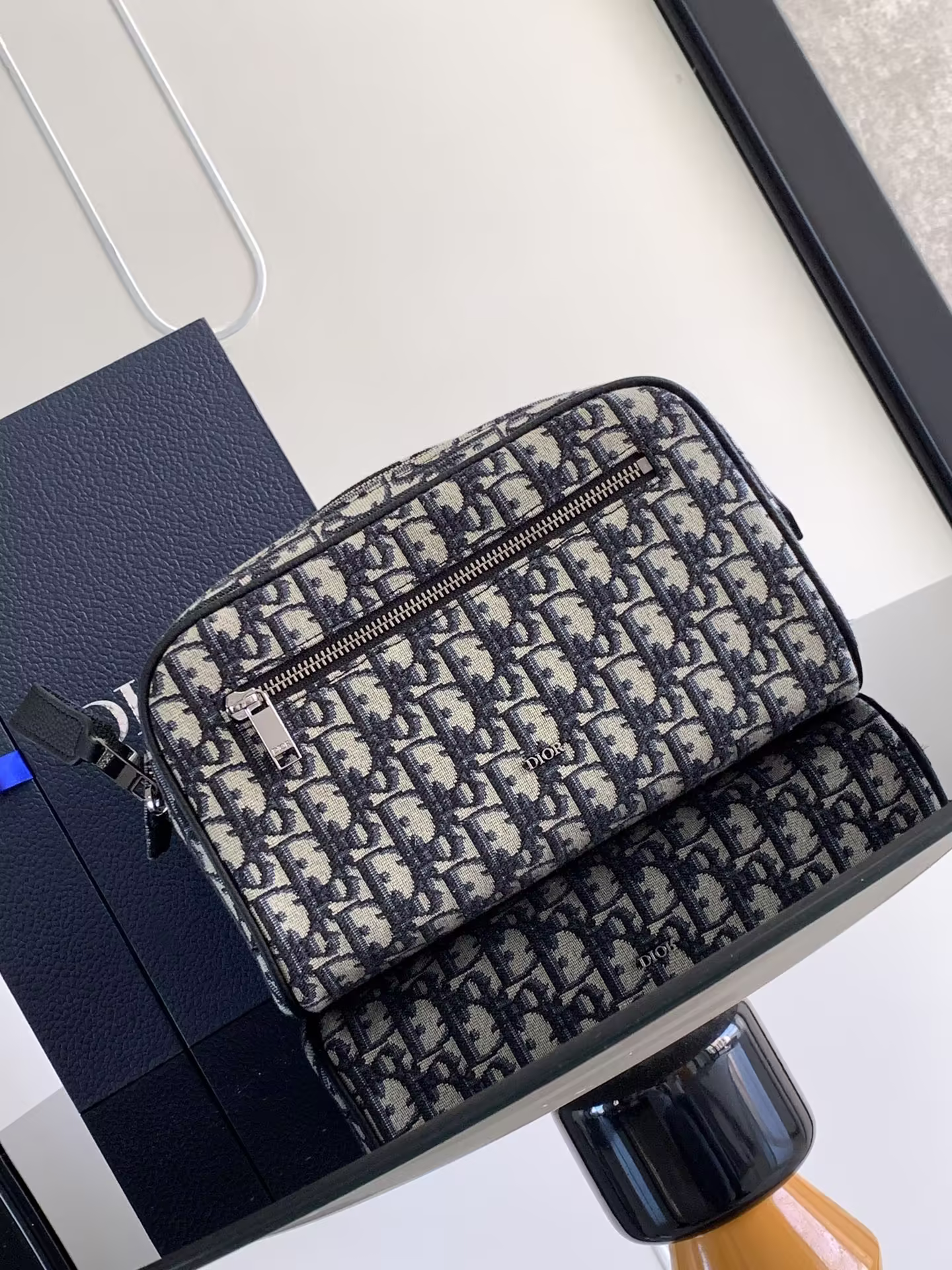 This toiletry bag combines functionality and simplicity in a beige and black Oblique print fabric crafted with black grained cowhide leather trimsDior logo embossed on the frontFront zipped pocket, one spacious zipped compartment and two slip pocketsLeather handles for carrying or slipping into a variety of handbagsNylon liningDouble-zip closure with grained cowhide leather handlesTwo internal slotsFront zipped pocketMetal cladding on the frontBrass Dior logo on the insideEmbossed Dior logo on the insideDust bag includedSize 24 x 494YKYModel No. 2ESCA494KY Zipper pocketFront metal claddingBrass Dior logoInterior Dior embossed logoInterior dust bagSize: 24.5 x 14.5 x 13 cmModel No.: 2ESCA494YKY_H27E-high-fashion factory