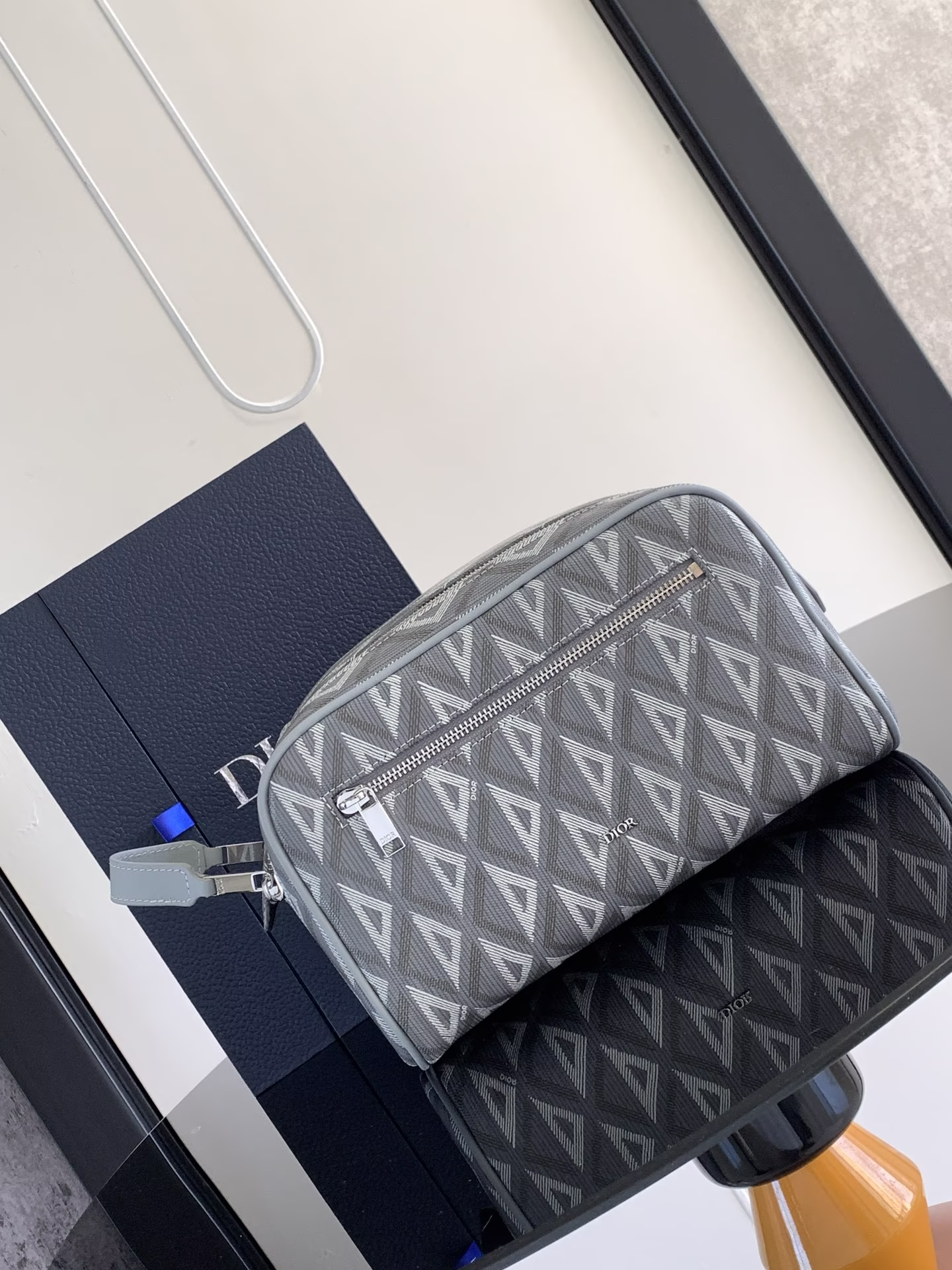 This toiletry bag combines functionality and simplicity, crafted in Dior Grey CD Diamond patterned canvas inspired by Dior's archives with smooth cowhide trimmings in the same hueDior logo on frontFront zipped pocket, one spacious zipped compartment and two slit pocketsLeather handles for carrying or slipping into a variety of handbagsDouble-zip closure in nylon liningGrained cowhide leather. Handles2 interior slit pocketsFront zipped pocketMetal cladding on frontBrass Dior logo on insideDior embossed logo on insideDust bag includedSize: 24.5 x 14.5 x 13 cmModel No.: 2ESCA494CDP_H42E-High-Fashion Factory