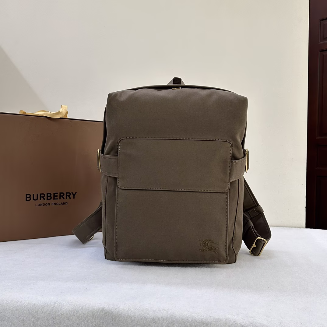 P1280 Burberry Italian crafted shoulder bag in cotton blend inspired by Burberry's iconic Trench coat embellished with embroidered equestrian knight logo (EKD) and brushed metal B-ring closure. Top handle. Adjustable shoulder straps. Two-way zipper closure. Exterior flap pocket; zippered exterior pocket. Laptop compartment. Adjustable side tabs. Brushed metal hardware. Embroidered equestrian knight logo (EKD) on front, size 33 x 10 x 43cm.