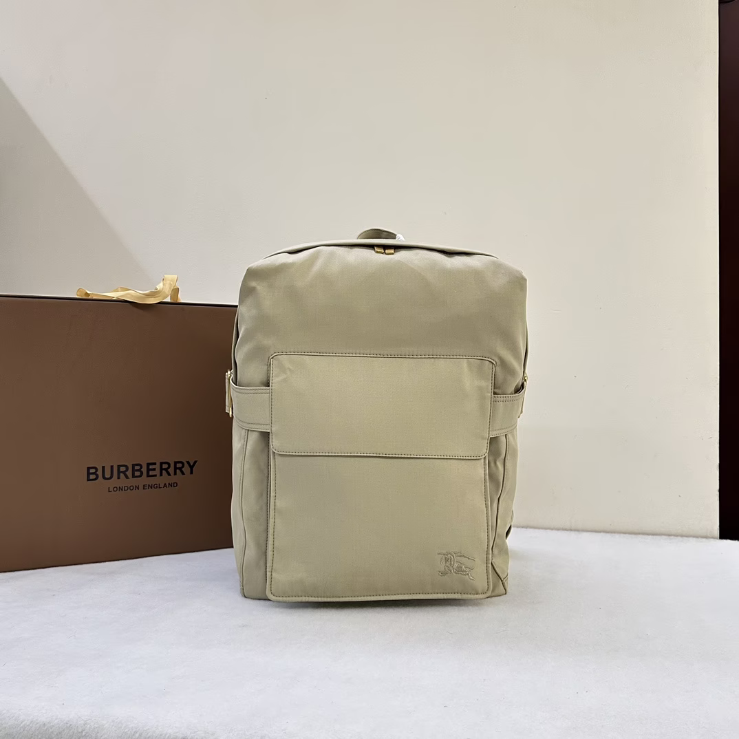P1280 Burberry Italian crafted shoulder bag in cotton blend inspired by Burberry's iconic Trench coat embellished with embroidered equestrian knight logo (EKD) and brushed metal B-ring closure. Top handle. Adjustable shoulder straps. Two-way zipper closure. Exterior flap pocket; zippered exterior pocket. Laptop compartment. Adjustable side tabs. Brushed metal hardware. Embroidered equestrian knight logo (EKD) on front, size 33 x 10 x 43cm.