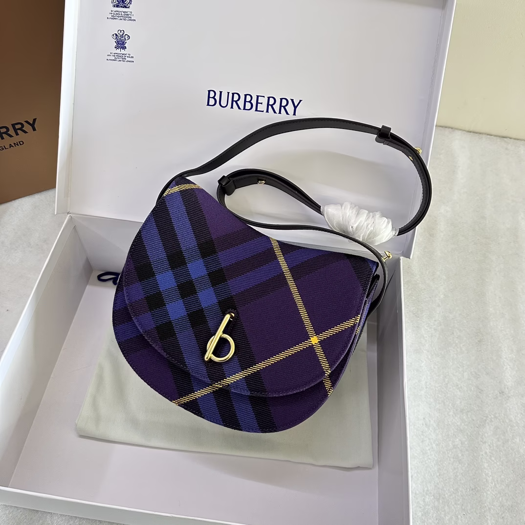 P1680 Medium Rocking Horse bag in wool tucked away, crafted in Italy, decorated with worsted Burberry check in a curved silhouette inspired by the rocking horse of childhood, flap closure with b-shaped hardware Leather shoulder strap, adjustable for switching between shoulder and cross-body bag shapes Adjustable leather shoulder strap. Top flap with b-ring closure. Interior slit pocket; exterior slit pocket. Hand-painted edges. Brushed metal hardware, dimensions 26 x 9.5 x 20.5 cm.