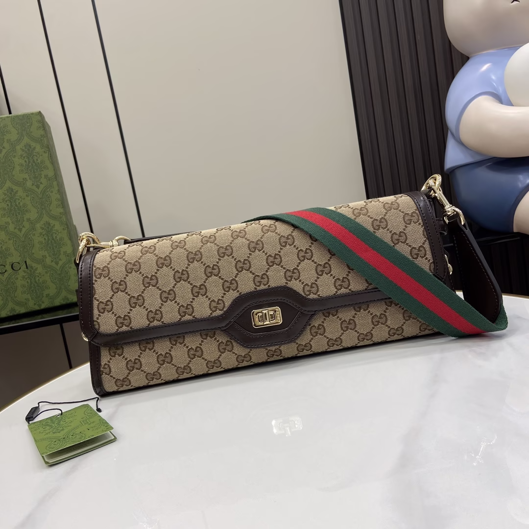 p1200🎁🎁Gucci Luce Medium Shoulder Bag, Gucci Luce bags exude a strong sense of playfulness and fun, "Luce" means "light" in Italian. "Classic GG canvas glamorizes the medium shoulder bag Brown leather piping and light gold-tone hardware add to the charm of the beige and ebony pattern Adjustable and removable red and green striped webbing straps are attached to the hardware loops through leather loops on both sides, giving the bag more functionality and structure Classic GG canvas in beige and ebony with loom-knit cotton thread backing, brown leather piping, light gold-tone hardware, cotton and linen piping and a light gold-tone hardware, a light gold-tone hardware, a light gold-tone hardware, a light gold-tone hardware, a light gold-tone hardware, a light gold-tone hardware, and a beige and ebony canvas. light gold-tone hardware, cotton-linen blend lining, interior: one zipped pocket with Gucci badge zipper closure Model: 786022 Size: 14 (L) x 36 (W) x 8 cm (Thickness) Colour: Brown/Canvas Created in Italy Model's height is 176 cm Maximum capacity: iPhone Pro Max/Plus, Airpods earphones, small wallet, and lipstick-High-quality imitation Factory