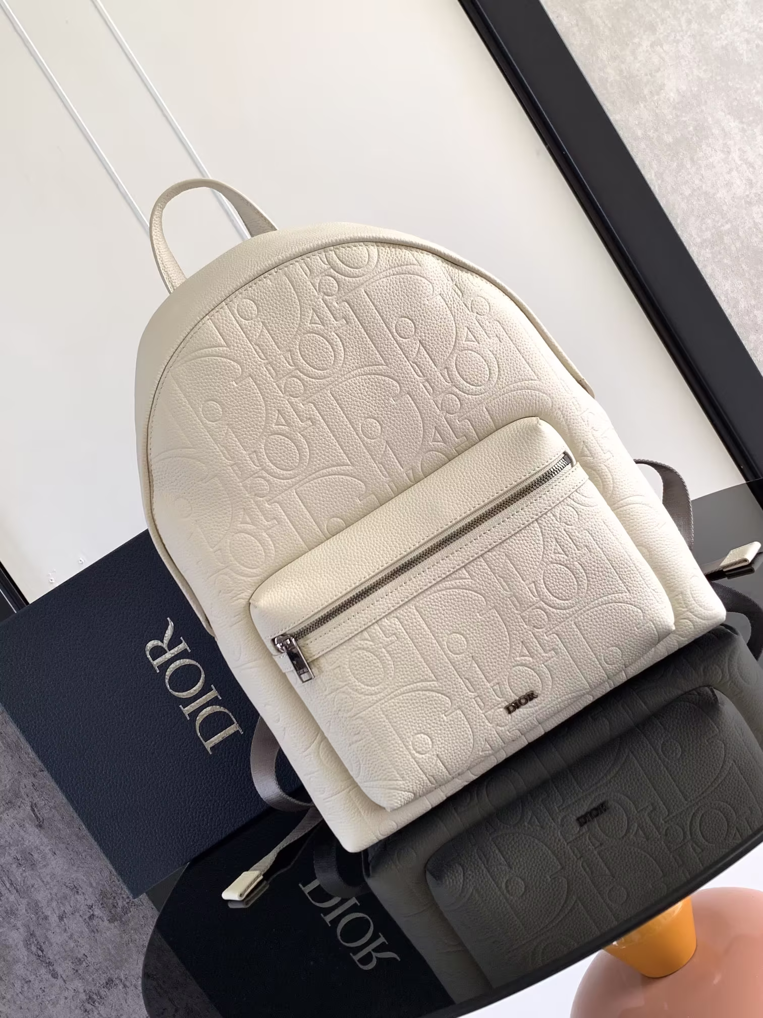The Rider 2.0 backpack is a new addition to the Fall 2014 Men's collection, featuring a full Dior Gravity print on a classic Dior piece. The leather is embossed with a classic motif that is delicately rendered in cowhide leather, and the Dior logo on the front highlights the craftsmanship of Dior's ateliers. The two-way zipper closure with a large zippered pocket on the front and an adjustable, padded shoulder strap are ideal for everyday use. Ideal for everyday use Size: 31 x 40 x 18 cm Number: 1ESBA199LLG_H00N