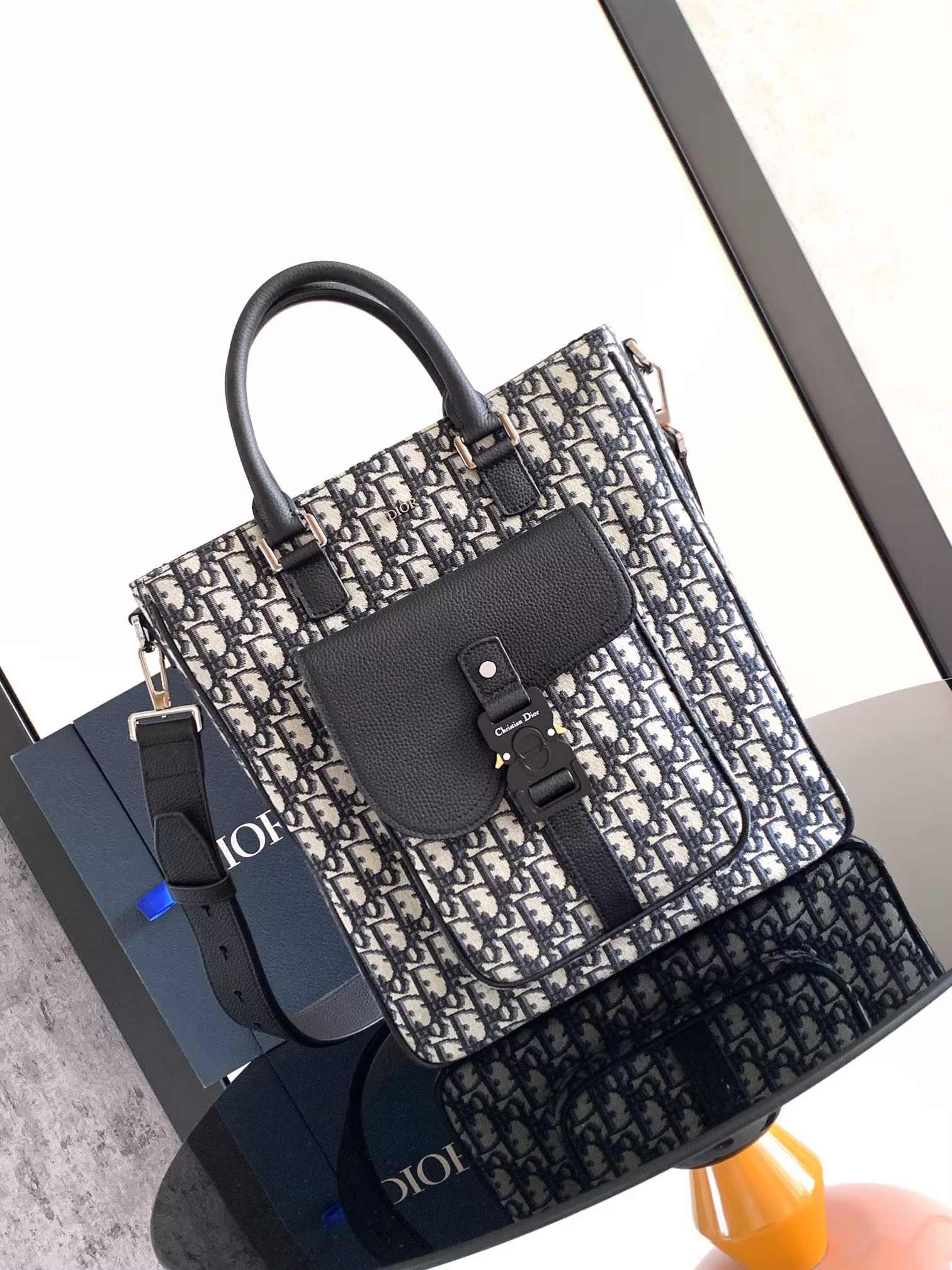 New to the Winter 2024 menswear collection, this saddle bag is practical yet stylish, crafted in apricot Oblique printed fabric with black grained cowhide details for an elevated look and Dior logo embellishment featuring a spacious main compartment for storing everyday essentials and a saddle flap pocket on the front with a Christian Dior logo aluminum clasp for storing your wallet, keys, earphones or cell phone for easy access with top leather handles and adjustable shoulder strap. Easy access with top leather handle and adjustable shoulder strapHandheld, shoulder or crossbodyBody: Cotton cowhide and tech fabricLining: Cowhide in tech fabricSpacious main compartmentInterior flat computer compartmentInterior zipped pocketFront flap pocket with CD logoAluminium buckleLeather top handleAdjustable Christian Dior logo nylon jacquard shoulder strapFront metal overlay with brass Dior logo Interior embellished with Dior embossed logoSize: 32 x 36 x 13.5 cmNo. 1ADSH241YKS_H03E-High-Fashion Factory