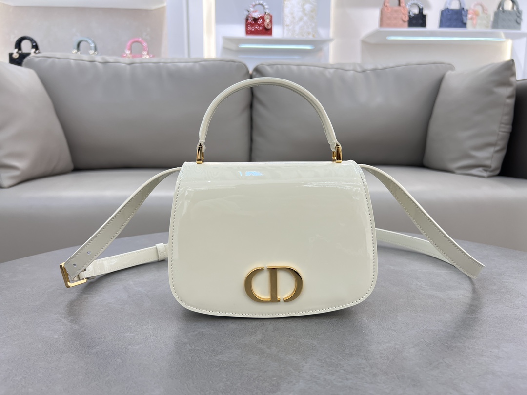 Medium 30 Montaigne Ave... White patent leather No. M9371UNQA This 30 Montaigne Avenue Top Handle is a new addition to the Ready-to-Wear collection for Winter 2014, offering elegance and modernity in a beautifully durable, richly textured blue patent cowhide leather that is a testament to Dior's mastery of craftsmanship. Triangular shaped lining and a back pocket for added practicalityMedium size with leather top handle and adjustable, removable shoulder strapCan be worn hand-carried, over the shoulder or cross-bodyFront adorned with the CD logoFlap closureLeather top handleAdjustable, removable leather shoulder strapTwo interior compartmentsInterior pocketInterior pocketBack pocket with dust bagMade in ItalyModel No. 6531Measurements:19×12×6-High-impression factory