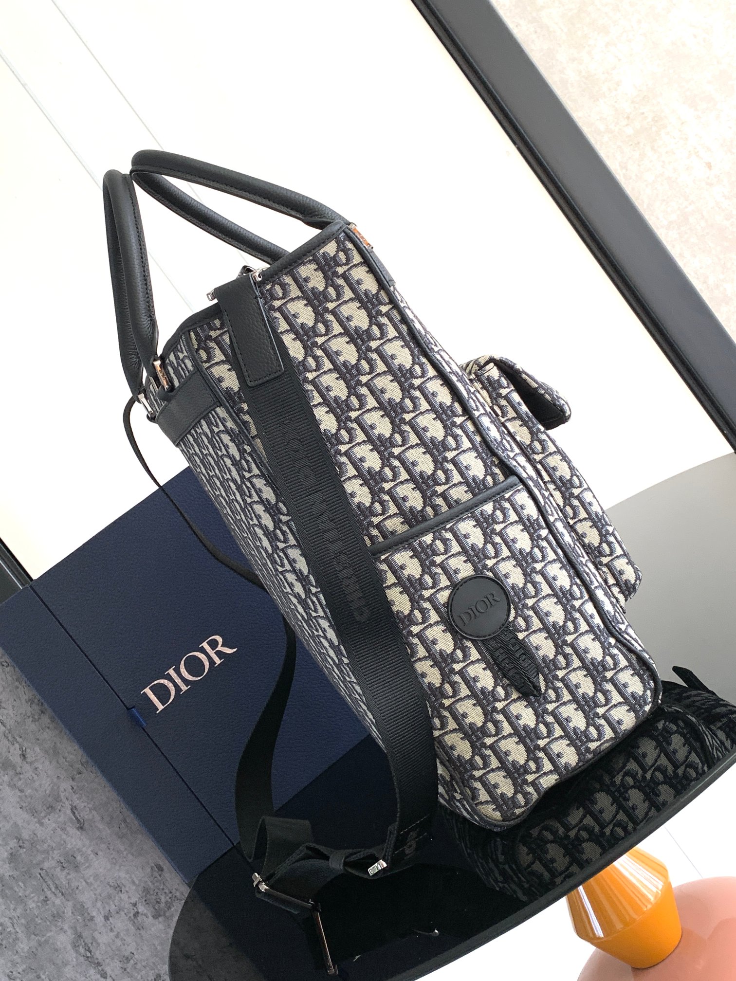 P1200 Dior Explorer collectionBeige and black Oblique print on all bodyBrass Dior logo on frontSide patch pockets with DIOR patchesInterior "DIOR" embossed logoFront flap pocket with DIOR logoAluminum buckleDual handlesChristian leather strap with Dior logoJacquard shoulder strap. Dior logo jacquardShoulder strapDetachable and adjustableCan be carried in hand or over the shoulderIncludes dust bagMade in ItalyMeasurements: 30 x 42 x 14.5 cm Model: 1ESSH069YIHMaterials: Oblique jacquard fabric, grained cowhide leather-High-quality imitation of the factory