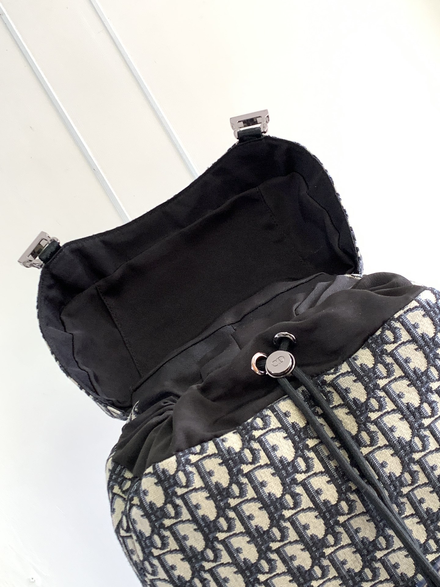 P 1220The Dior 8 backpack is a new addition to the summer 2014 menswear collection with a flap design that pays homage to the fabulous outdoors and Dior's fashionable style.Crafted in beige and black Oblique printed fabricsThe main compartment has a flap with Dior 8 clasp to organize your daily essentialsFront zipper pocket and mesh fabric side pockets for easy access to your keys or earphonesPractical and versatile, it's the perfect addition to any look. Beige and black Oblique printInterior with Dior embossed logoPadded mesh fabricAdjustable shoulder strapLeather handlesRear side of bag with quilted tech-knit fabricReinforced with Dior logoFlap closure with 2 Dior 8 claspsFront zipped pocketSides with 2 mesh fabric side pocketsInterior zipped pocket with dust pocketNo. 1 EIBA187YKK 1EIBA187YKY_H27E1213Size: 31 x 50 x 18 cm-High-Fashion Factory