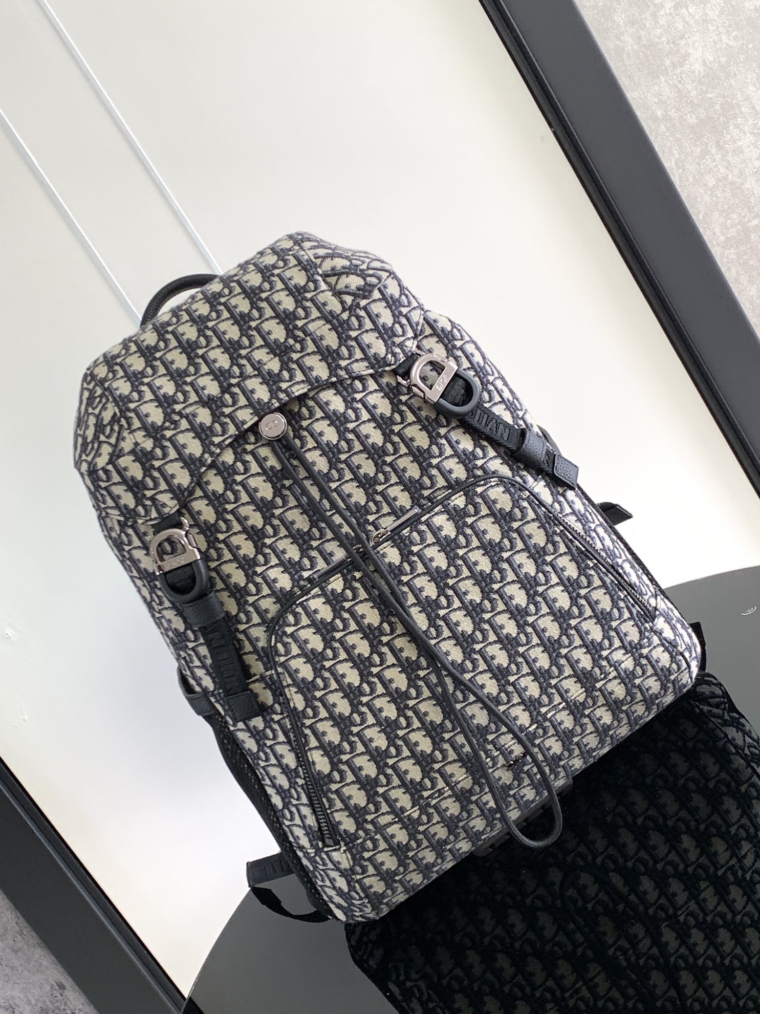 P 1220The Dior 8 backpack is a new addition to the summer 2014 menswear collection with a flap design that pays homage to the fabulous outdoors and Dior's fashionable style.Crafted in beige and black Oblique printed fabricsThe main compartment has a flap with Dior 8 clasp to organize your daily essentialsFront zipper pocket and mesh fabric side pockets for easy access to your keys or earphonesPractical and versatile, it's the perfect addition to any look. Beige and black Oblique printInterior with Dior embossed logoPadded mesh fabricAdjustable shoulder strapLeather handlesRear side of bag with quilted tech-knit fabricReinforced with Dior logoFlap closure with 2 Dior 8 claspsFront zipped pocketSides with 2 mesh fabric side pocketsInterior zipped pocket with dust pocketNo. 1 EIBA187YKK 1EIBA187YKY_H27E1213Size: 31 x 50 x 18 cm-High-Fashion Factory