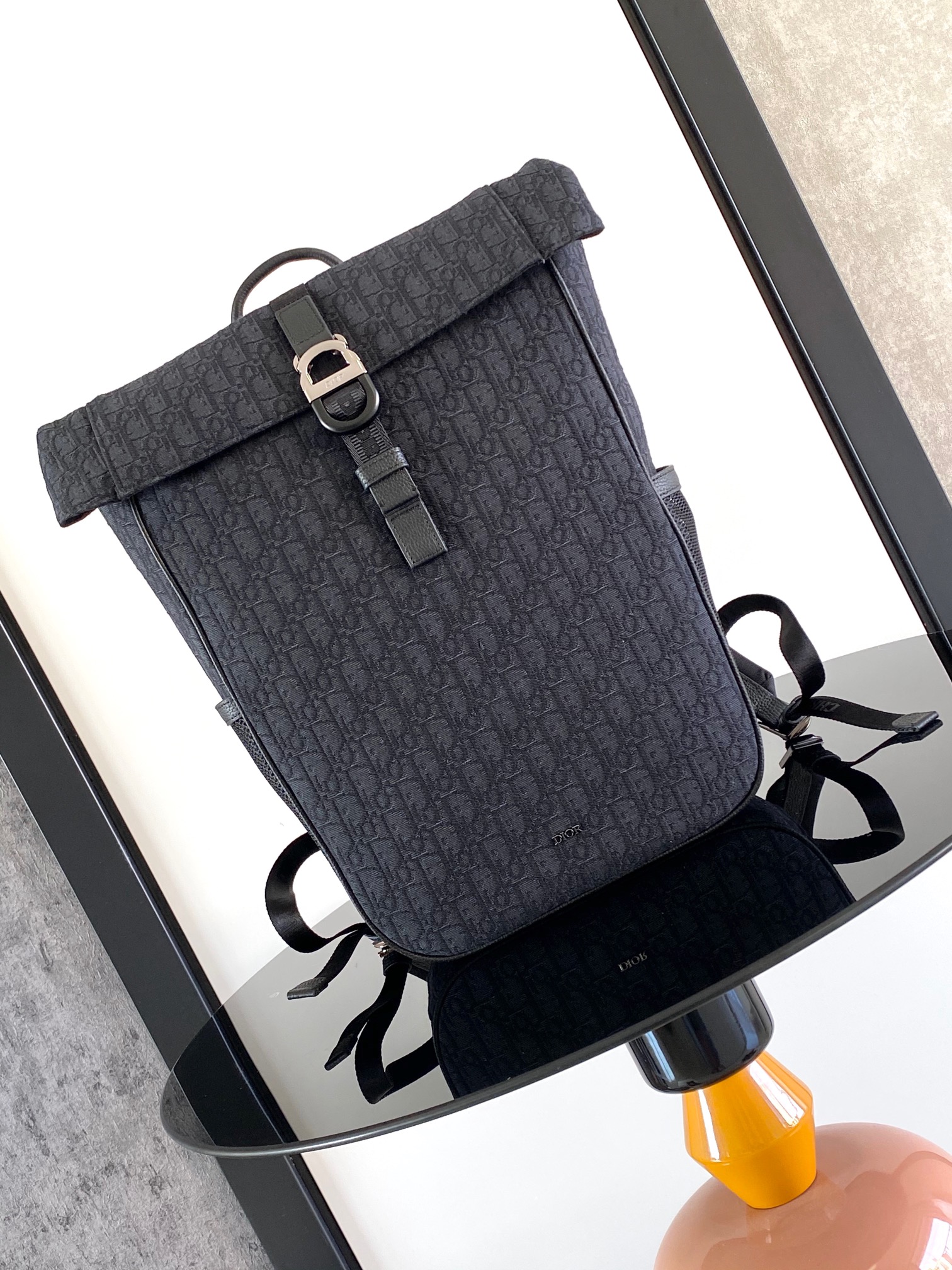 The Dior 8 roll-top backpack, a new addition to the Spring 2025 menswear collection, is stylish and functional, crafted from materials such as black Oblique printed fabric and enhanced with a self-buckle flap with Dior 8 buckle. The front, adorned with the Dior logo, features a spacious main compartment, two slash pockets, and two mesh fabric side pockets for practical use and to add the finishing touch to a casual look Body: cotton Technical fabricBull leatherLining: CottonTechnical fabricBull leather main compartment with self-fastening flap and Dior 8 buckleInterior flat computer compartmentInterior slit pocketsSide mesh fabric pocketsLeather top handlesAdjustable padded shoulder strapPadded mesh fabric backDior logo on frontMetal overlayBrass Dior logo on frontDior logo embossed on interiorInterior Dior embossingPackage with dust bagSize: 39 x 42 x 13 cm (L x H x W) 13 cm (L x H x W)Main compartment for 1 15-inch laptop, A4 documents and 1 tabletSide pockets for various cell phone modelsNo. 1ESBA216YK-High-Fashion Factory