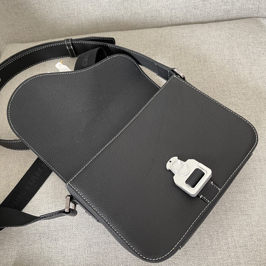 Image [7]-This saddle bag with shoulder strap is the season's smartest and most stylish crafted in black grained cowhide leather with contrasting stitching and a saddle-inspired flap embellished with an aluminum clasp for a touch of styleMiniature style with a spacious interior and a patch pocket for added sophisticationCan be worn on the shoulder or cross-body with an adjustable leather and Christian Dior jacquard shoulder strap Model. D8016Size 23-18-6Black grained cowhide with contrasting stitchingDior embossed logo on insideAdjustable leather and nylon Christian Dior logo jacquard shoulder strapFlap closureAluminum buckle embellished with the Christian Dior logo and the initials CDInterior patch pocketInterior patch pocket with dust bagMade in Italy191701100-High-quality bags