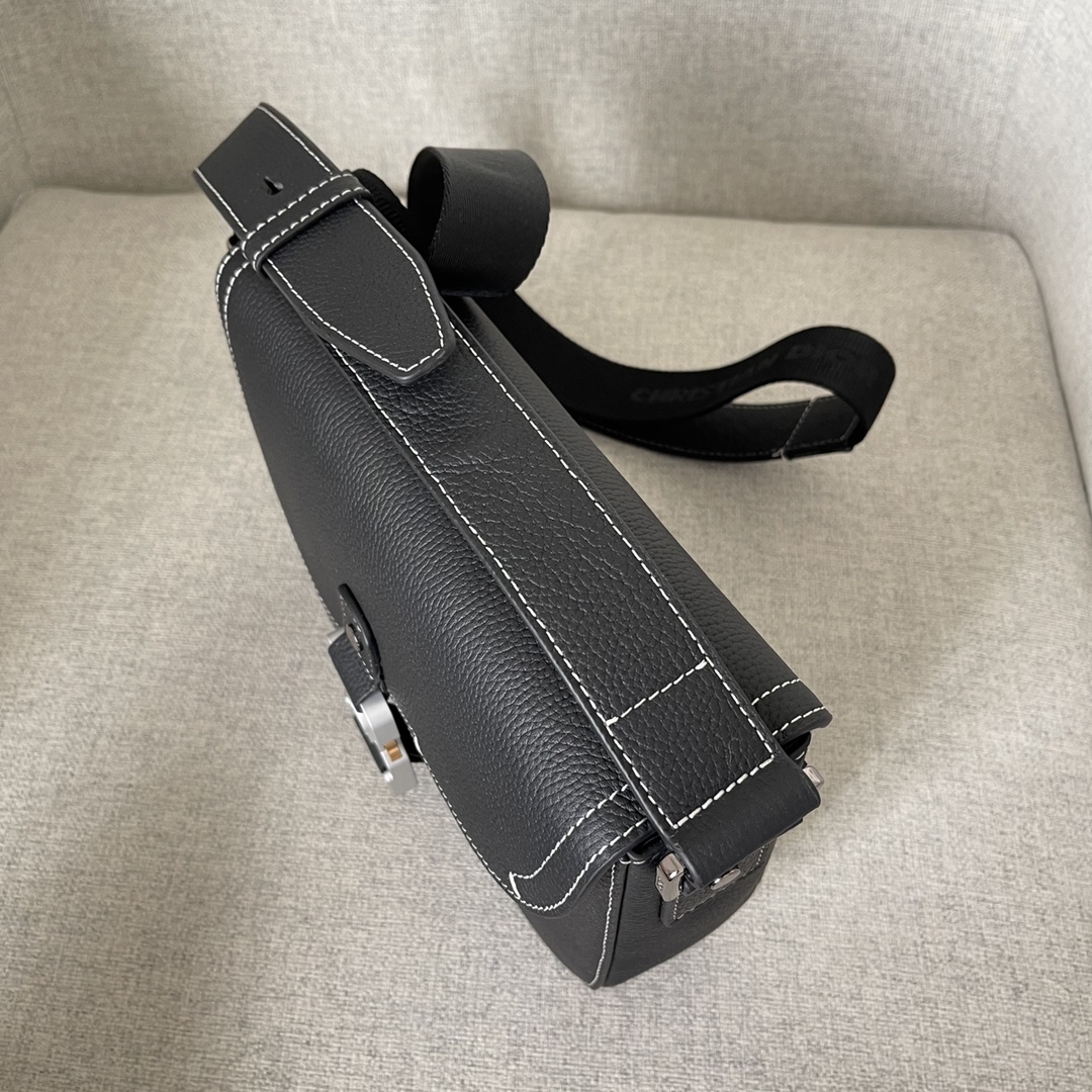 Image [5]-This saddle bag with shoulder strap is the season's smartest and most stylish crafted in black grained cowhide leather with contrasting stitching and a saddle-inspired flap embellished with an aluminum clasp for a touch of styleMiniature style with a spacious interior and a patch pocket for added sophisticationCan be worn on the shoulder or cross-body with an adjustable leather and Christian Dior jacquard shoulder strap Model. D8016Size 23-18-6Black grained cowhide with contrasting stitchingDior embossed logo on insideAdjustable leather and nylon Christian Dior logo jacquard shoulder strapFlap closureAluminum buckle embellished with the Christian Dior logo and the initials CDInterior patch pocketInterior patch pocket with dust bagMade in Italy191701100-High-quality bags