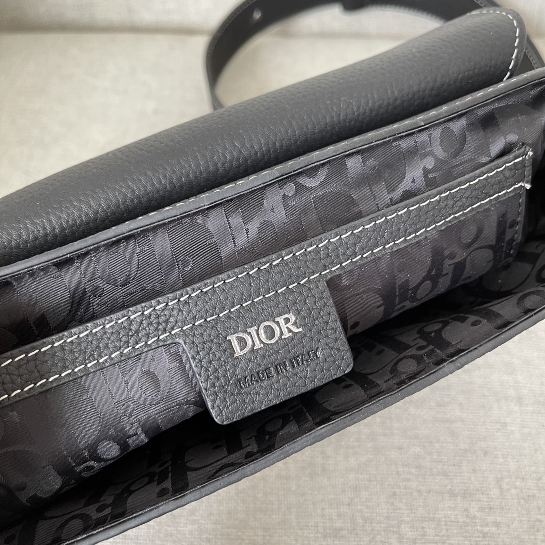 Image [9]-This saddle bag with shoulder strap is the season's smartest and most stylish crafted in black grained cowhide leather with contrasting stitching and a saddle-inspired flap embellished with an aluminum clasp for a touch of styleMiniature style with a spacious interior and a patch pocket for added sophisticationCan be worn on the shoulder or cross-body with an adjustable leather and Christian Dior jacquard shoulder strap Model. D8016Size 23-18-6Black grained cowhide with contrasting stitchingDior embossed logo on insideAdjustable leather and nylon Christian Dior logo jacquard shoulder strapFlap closureAluminum buckle embellished with the Christian Dior logo and the initials CDInterior patch pocketInterior patch pocket with dust bagMade in Italy191701100-High-quality bags