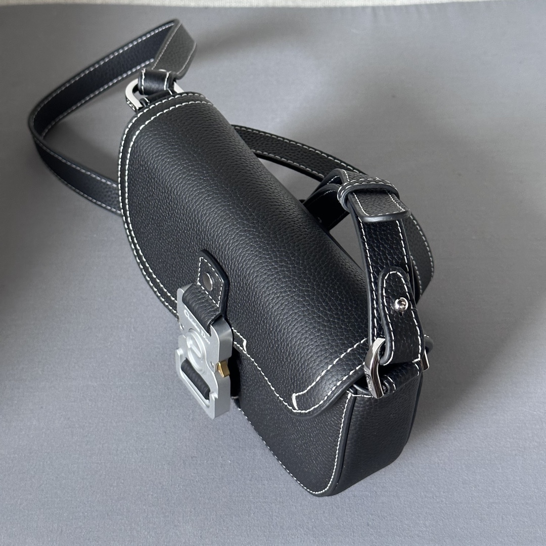 This saddle flap messenger bag is a sleek design with a flap for sophisticated elegance that elevates the saddle collection. Crafted in black grained cowhide with contrasting stitching, the saddle flap is embellished with the Christian Dior logo and an aluminum buckle. The miniature style is finished with a detachable, adjustable leather shoulder strap that can be carried in a handheld, over the shoulder, or crossbody.Nylon lined interior slit pocketMagnetic patch pocket at backModel number 8025Size 19.5-13-4.3Detachable, adjustable leather shoulder strapDior logo embossed on insideInterior dust bag19170960
