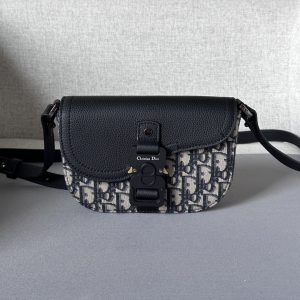 This saddle flap messenger bag features a sleek design with a flap for sophisticated elegance, elevating the saddle collection in beige and black Oblique print fabrics with a black grained cowhide leather saddle flap and Christian Dior logo aluminum clasp miniature style with a detachable, adjustable leather shoulder strap that can be carried by hand, over the shoulder, or crossbody.Nylon lined interior slit pocketMagnetic back patch pocketModel number 8022Size 19.5-13-4.3Detachable, adjustable leather shoulder strapBrass Dior logo on metal overlay on frontDior embossed logo on insideInterior dust bag19170900